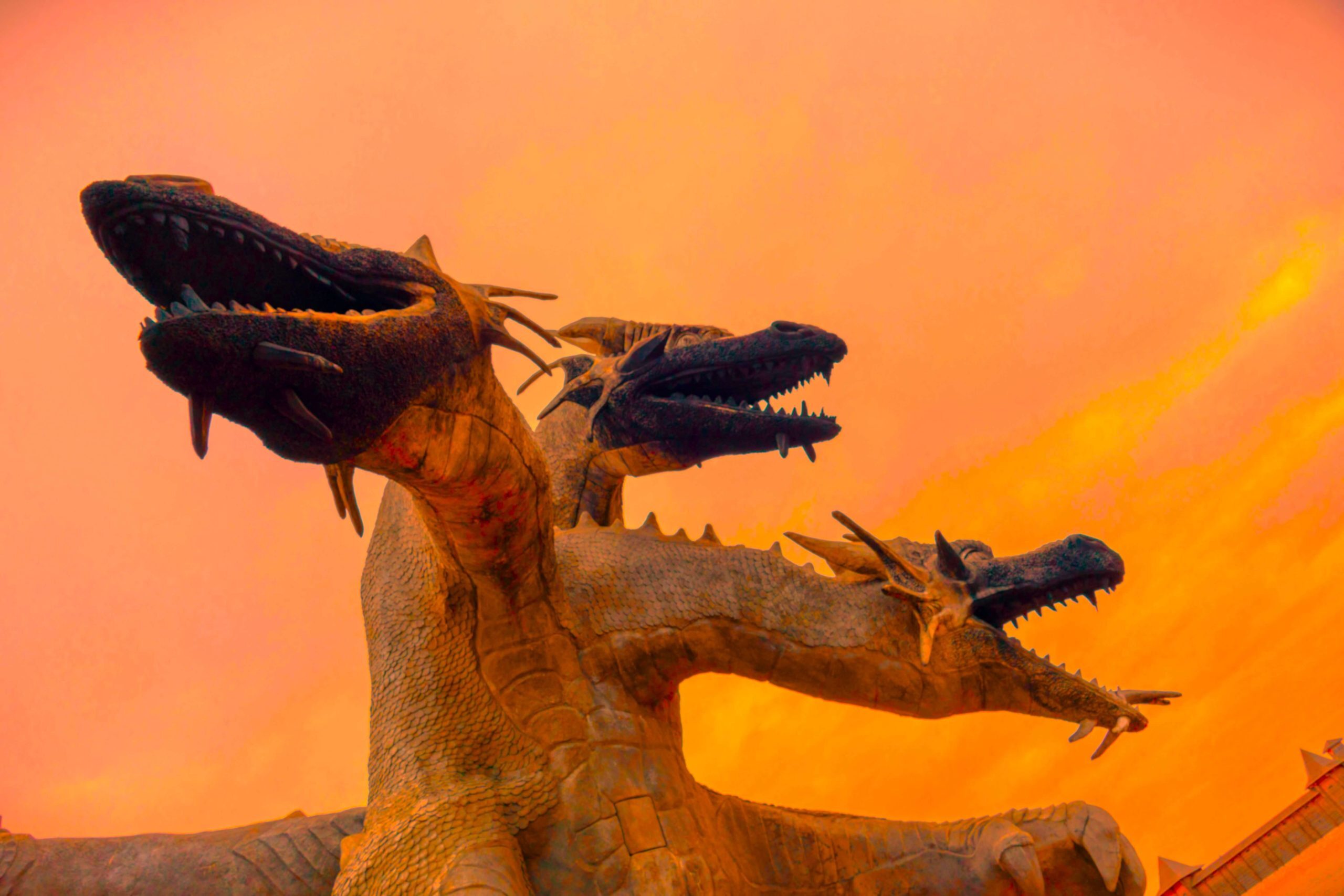 Three headed hydra against an orange sky